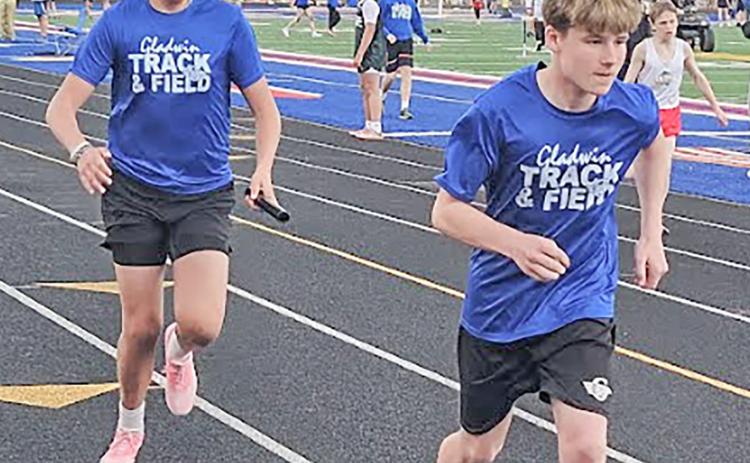 Bentley Grice and WiIliam Kruske accomplish a successful handoff in their relay.