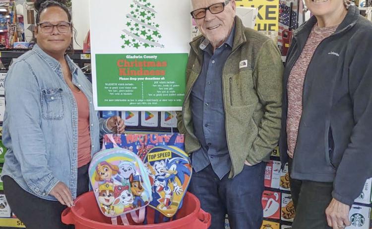 Pictured from left to right are Brandi Knake, Assistant Manager of the Dollar General in Albright Shores; and Edwin and Gail Wistie, Christmas Kindness Donation Can Distributors.