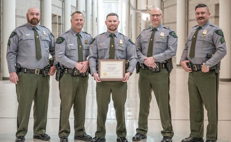 Michigan DNR Conservation Officer Kyle McQueer is pictured with leadership from the DNR Law Enforcement Division, including (left to right) Acting 1st Lt. Stephen Mooney, Chief Brandon Kieft, McQueer, Acting Asst. Chief Gerald Thayer and Sgt. Chris Holmes.