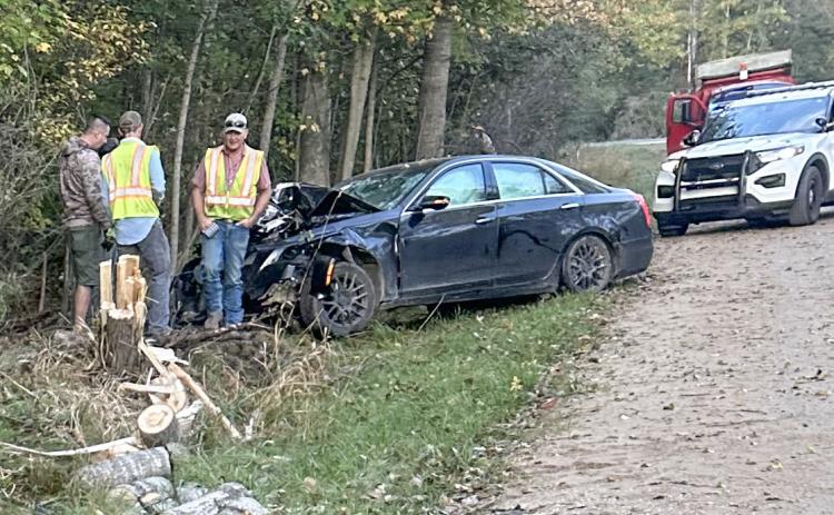 Responders survey the accident from the stolen car on October 4.