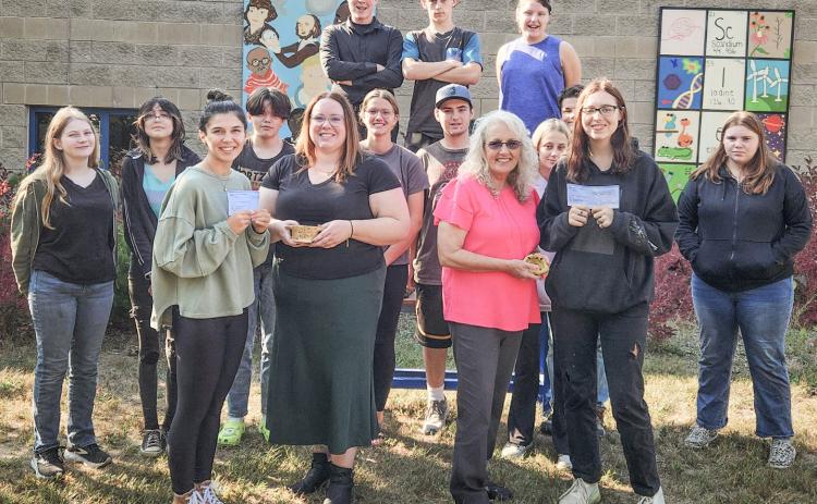 Pictured in front row, left to right: Advanced art students, Aubrey Fairchild and Harmony Albain; and Anna McNeil and Lori Stout from the Council on Aging. Second row, left to right: Aubrey Shanahan, Veronica Gower, Kempton Harvey, Charlotte Mawhorter, Isaac Friesen, Faith Hude, Wyatt Lier, and Brianna Vincent, Back row, left to right: Mason Heppner, Keegan Estes, and Emily Hough.