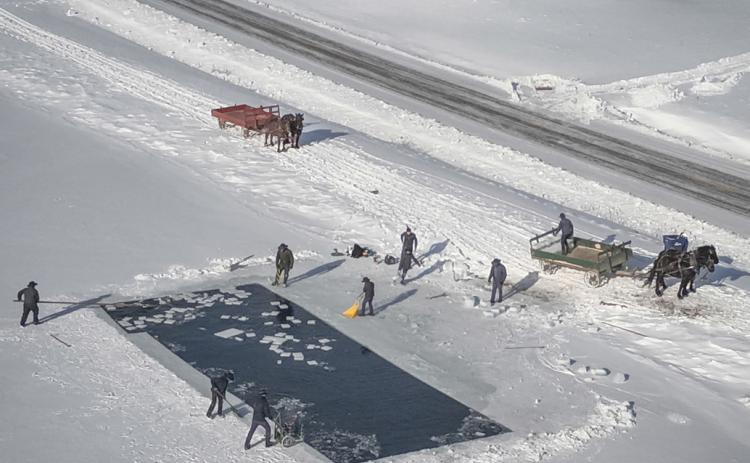 An aerial view of Amish cutting and collecting squares of ice and putting them on to horse drawn carts. PHOTOS PROVIDED BY ROGER HAINES