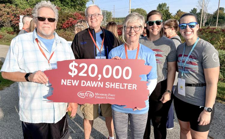 New Dawn Shelter is pictured receiving a donation from Members First Credit Union.