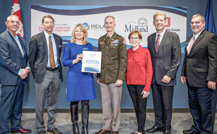 Gathered after the signing of the agreement for the General Investigation study with the Corps of Engineers are pictured, left to right: Mark Bone, chair, Midland County Board of Commissioners; J.W. Fisher and Lee Ann Keller, co-chairs of the Midland Business Alliance (MBA) Advisory Committee on Infrastructure; Lt. Col. Wallace Bandeff, commander, U.S. Army Corps of Engineers Detroit District; Maureen Donker, mayor, City of Midland; Brad Kaye, Midland city manager; and Tony Stamas, president and CEO, MBA.