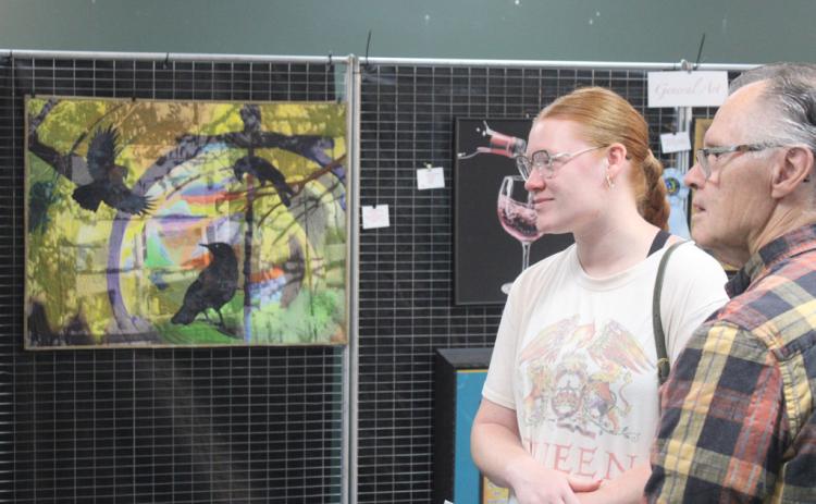 Lynn Morgan and his granddaughter Kailah check out the goods at the Art Show &amp; Sale Saturday morning at the GAFT Theater.