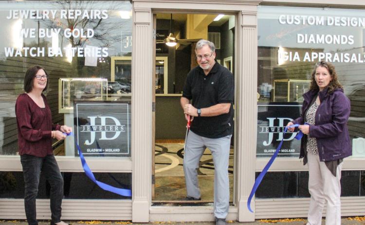 J.D. Jewelers owner David Jenkins (center) cutting the ribbon with Vicki Pickard (right) and Carrie Will, Gladwin Chamber of Commerce Executive Director (left), at the new store location at 111 Cedar Avenue.