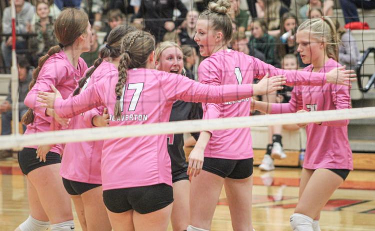 The Beaverton volleyball team celebrates after winning a critical point.