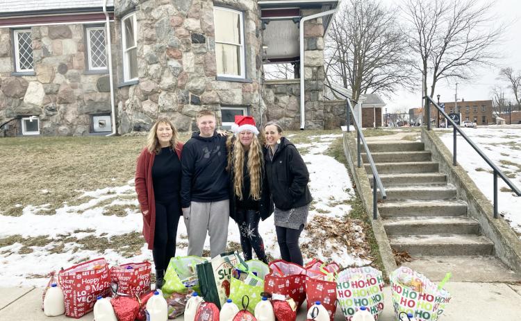 Helping pass out the food curbside were Owner Sheryl Sacry, Team Member Kooper Brewer, Kortni; and Chef Monica Antes.