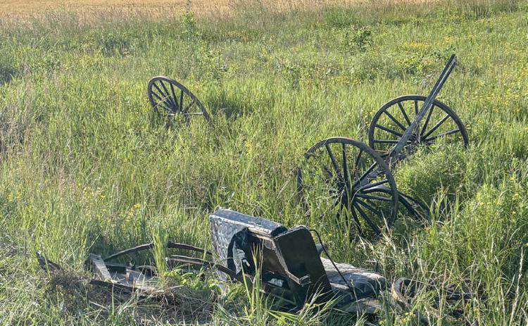 The broken remains of an Amish buggy are strewn on the side of a road after a crash with a vehicle on Wirtz Road on Friday.