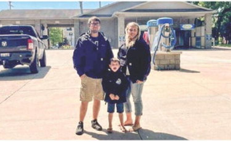 The Aeschliman family outside of their new business Small Town Suds Carwash.