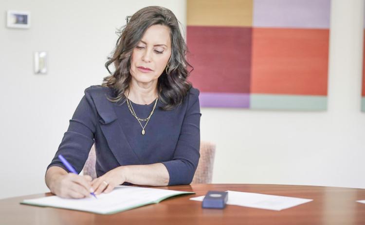 Governor Whitmer is pictured signing six commonsense bills into law.