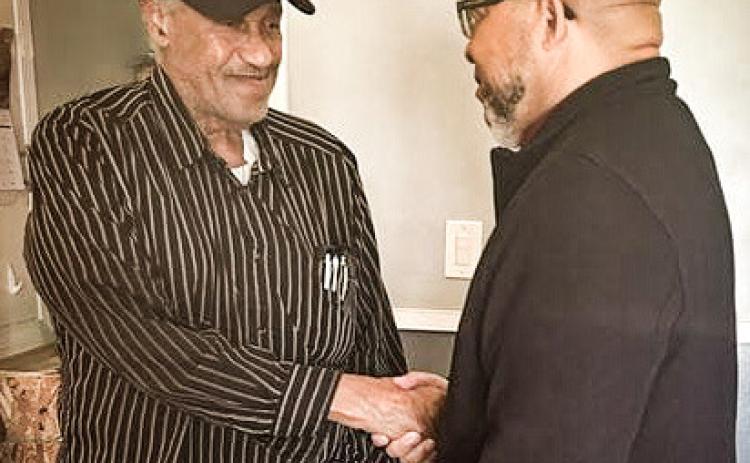 Lawrence Brooks (left) shakes hands with MVAA Director Brian L. Love.