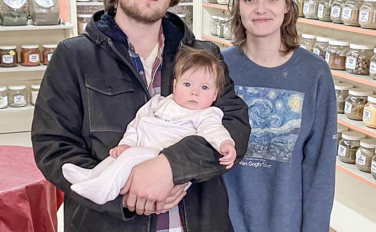 Gabriel Hadley is pictured with baby Meredith, and wife, Lilly.