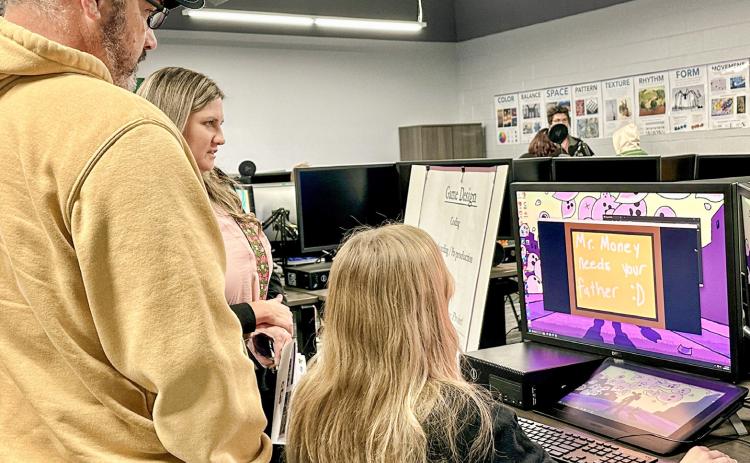 A Digital Media student interacts with visitors in the new lab, demonstrating industry-standard software and equipment while explaining how the program helps build technical skills.