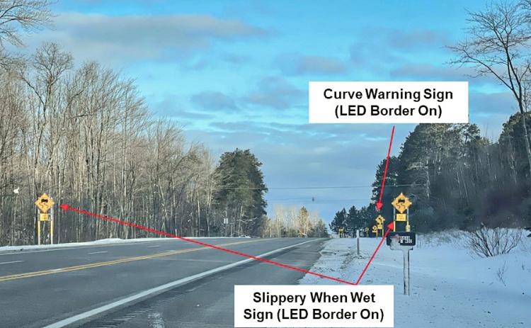 Example of activated slippery curve warning system signs on westbound M-32 near Gaylord. MICHIGAN STATE UNIVERSITY