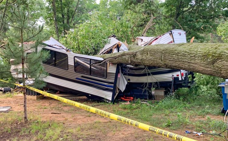 Tree falls onto camper trapping occupant