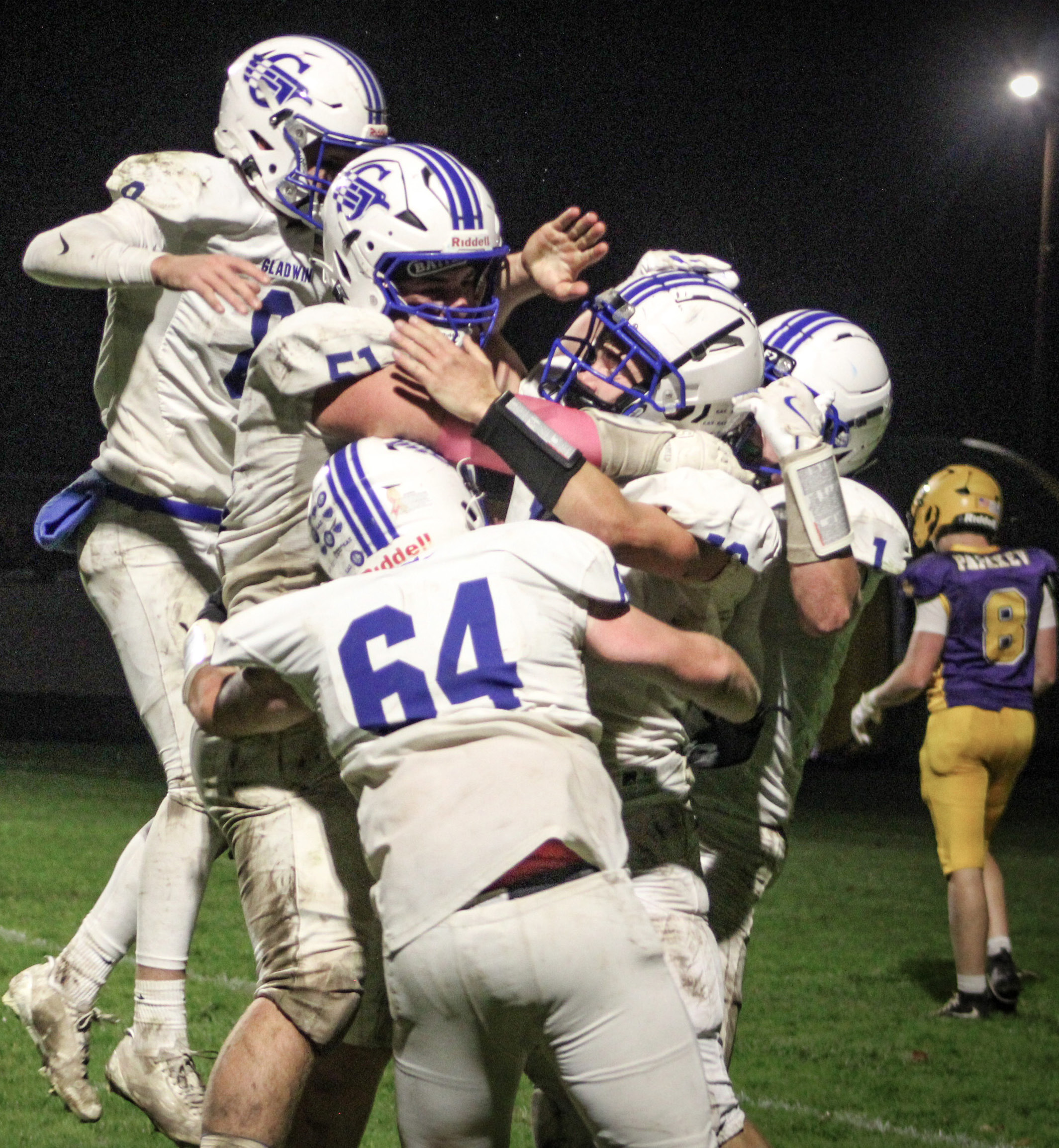 Jacob Pahl is mobbed by his teammates after catching a touchdown pass on the last play of the game Friday night to give Gladwin a 26-20 victory over Ogemaw Heights and the Jack Pine Conference Division 1 championship. OGEMAW