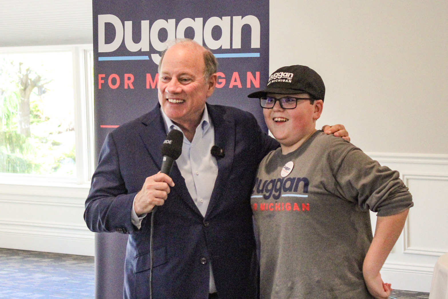 Candidate for Governor Mike Duggan and one of his biggest local supporters, Beaverton Junior High School student Tanner Oard, meet the people at a rally at Riverwalk Grill Saturday.
