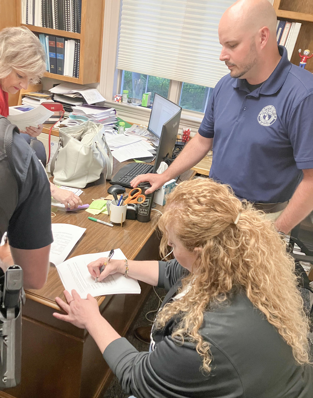 Gladwin Mayor Sarah Kile signs a new contract between the city and its police officers, represented by POAM Business Agent Adam Walser, after Monday’s City Council meeting.