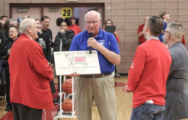 Gladwin’s Terry Brokoff presents Beaverton coach Roy Johnston with a placard commemorating the 100th time Johnston led the Beavers into the “Battle for Butch” prior to Friday night’s game.