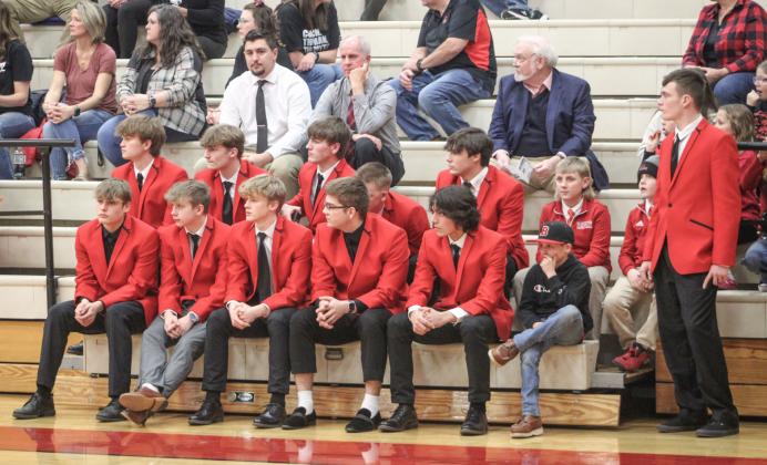 Coach Roy’s team dressed for success in red Coach Roy sports jackets as they watched the girls’ team take on Gladwin prior to their own game Friday night.