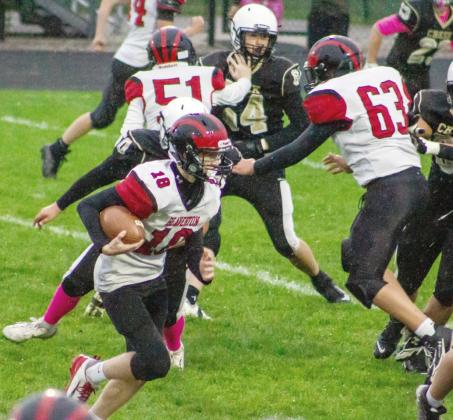 Mitchell Malmo looks for running room during the Beaverton junior varsity football team’s game at Bullock Creek Thursday.