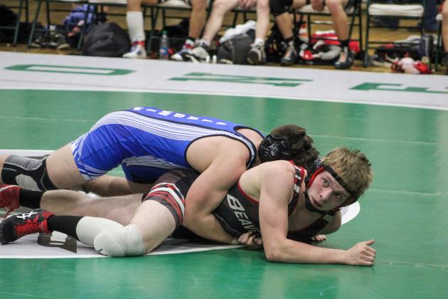 Gladwin First Team All-Conference selection Gaven Evans-Ferguson gets a grip on Beaverton Honorable Mention honoree Ian Krezenski at 165.