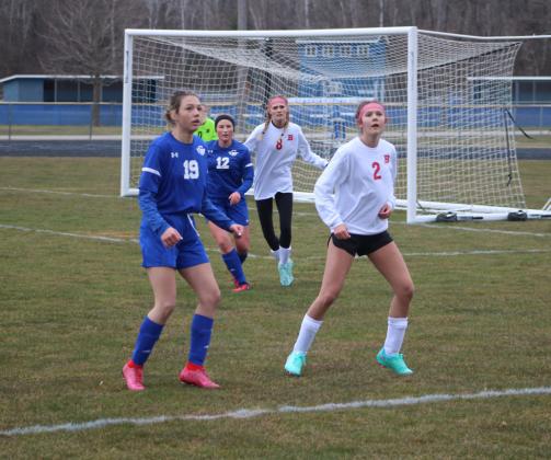 Gladwin’s Lauren Nobach and Beaverton’s Emily Skotynsky eagerly await a throw-in.