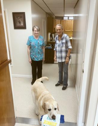 Becky Priemer and Terri Taylor send Lance off on a delivery during another work day at the Gladwin Veterinary Clinic. All three longtime employees of the business will be retiring on Aug. 28.