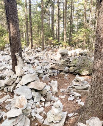 Pictured above, cairns litter the trail near Stratton Mountain. Inset photo is the fire tower at the top of Stratton Mountain. Pictured at right, the AT goes through large granite boulders. Inset photo, 500 mile-marker to Mount Katahdin in Maine.