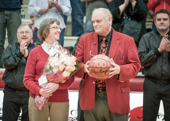 Beaverton basketball coach Roy Johnston and his wife Judy share a moment during a ceremony honoring Johnston for achieving his 700th career victory. He added 133 more before retiring at the end of this season.