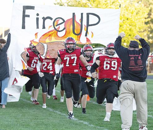 The Beaverton football team breaks the paper and takes the field with fire prior to a big 54-8 victory over Pinconning Friday night that put a triumphant stamp on an eventful Homecoming weekend for the community. See the story on B- 1! PHOTO BY JESSICA KELLER