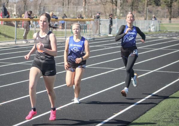 Gladwin’s Jewelia Anderson (left) and Callie Mead push each other toward the finish line during a recent race.