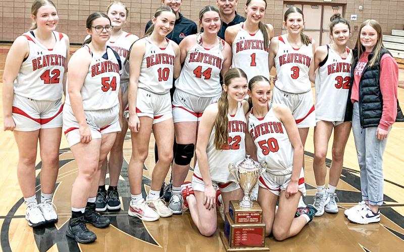 The Beaverton girls’ basketball players and coaches posed with the hardware after beating rival Gladwin for the Cedar Cup last Wednesday.