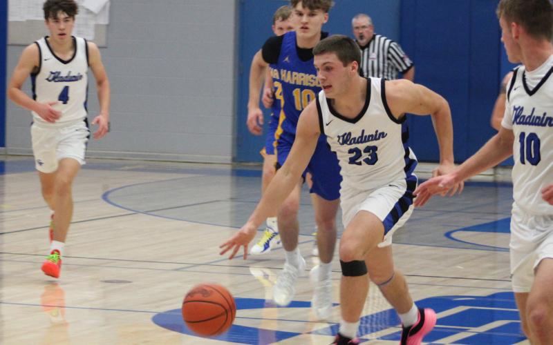 Colton Pfenninger runs the floor during Gladwin’s 67-47 victory over Harrison in the home opener on Friday night.