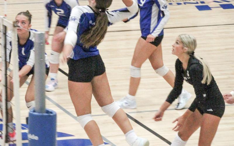 Gladwin’s big hitter Ansley Mausolf gets up and at ‘em during last Wednesday night’s impressive threeset victory over Ogemaw Heights.