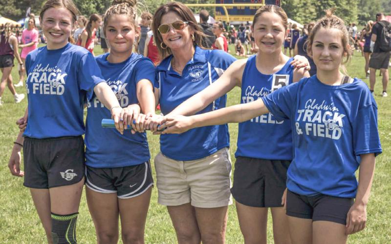 Gladwin Junior High’s (left to right) Arliena Grant, Brooklyn Loso, Coach Ann Clayton, Liliana Gutierrez and Breanna Aalderink get together for a picture at the Megastars Meet Thursday. LEON LANGRIDGE