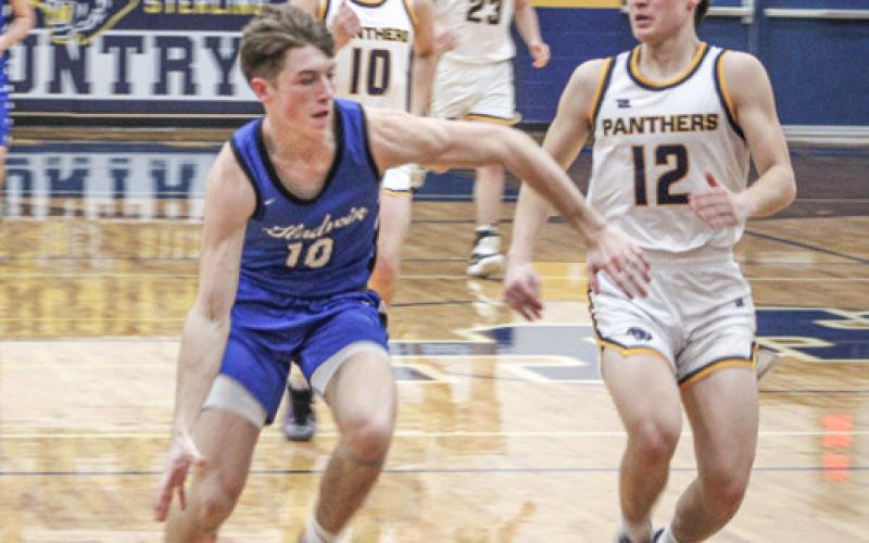 Gladwin’s Seth Mead tries to force his way to the basket during Friday night’s district final loss at Standish.
