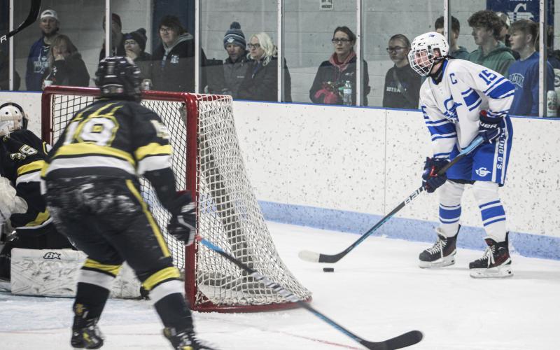 Gladwin’s Treyton Siegert camps out behind the net and looks for an open teammate during Saturday’s victory, which was the third in four days for the Flying G’s.