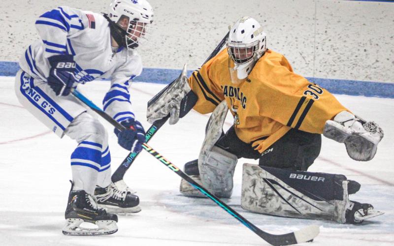 Gladwin’s Braeden Guzman slips a back-hander into the net during Saturday’s 6-3 victory over Cadillac.