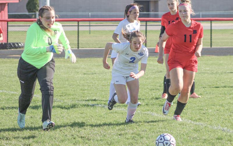 Beaverton goalie Anna Mannigel, Gladwin’s Vivian O’Callaghan and Beaverton’s Caroline Ogendahl converge on the ball in the box during Gladwin’s victory Thursday.