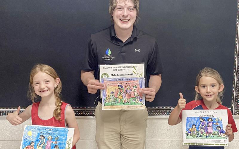 Tristan Hewitt is pictured with Sage Lane and Lisa Payne.