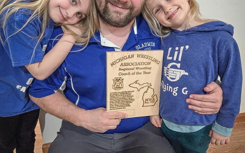 Gladwin’s Buddy Goldsworthy and two of his biggest fans celebrate his being named Regional Coach of the Year.