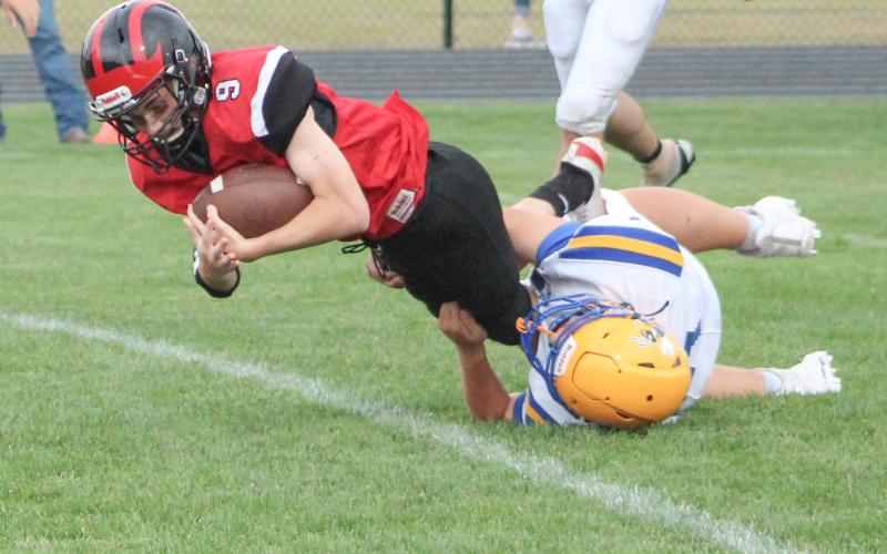 Colton Miller is brought down by a Harrison tackler on the way to a junior varsity win for Beaverton last week.