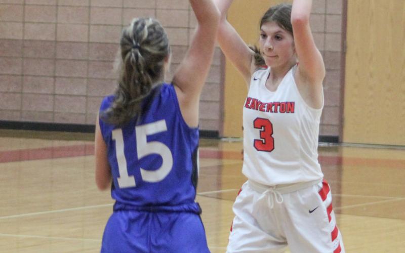 Beaverton’s Sayde Woodruff surveys the floor while Gladwin’s Madisyn Lockwood defends during Thursday night’s junior varsity contest.