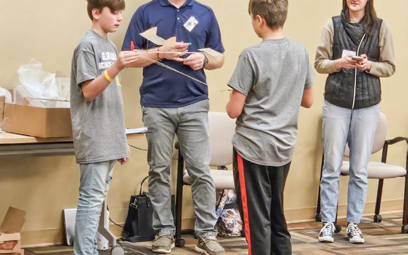 Mayson Cross and Gunner Poynter preparing their rubberband plane to fly. They had a successful flight of 15 seconds.
