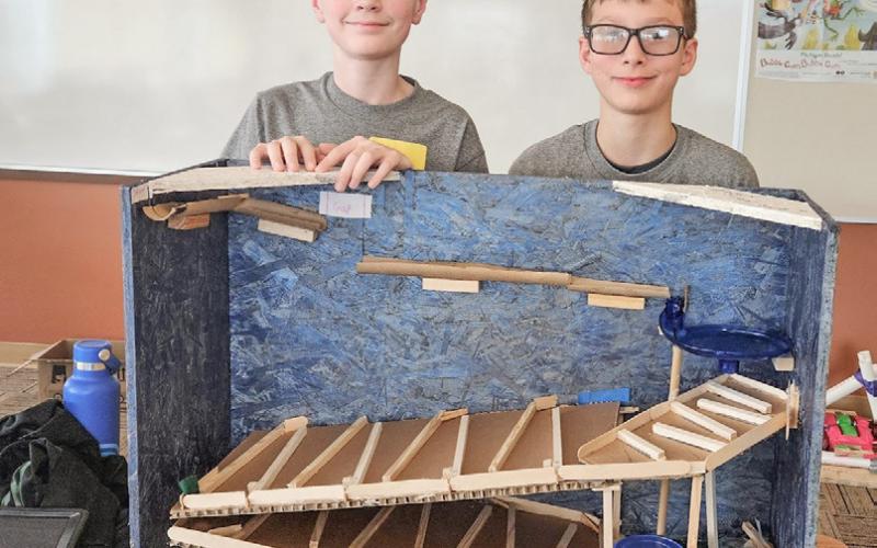 Ivan Christensen and Cole Lockwood with their roller coaster which had to move a marble for a specific amount of time.