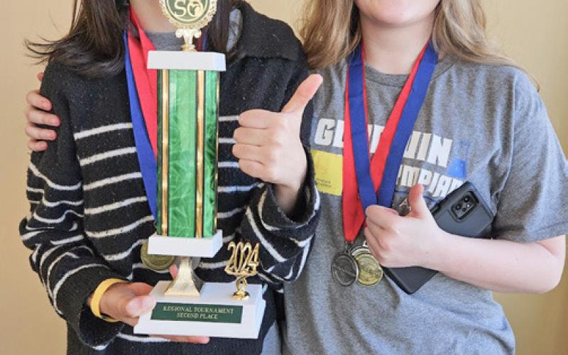 Veronica Gower and Myla Connelly proud of the trophy the team earned for second place overall.