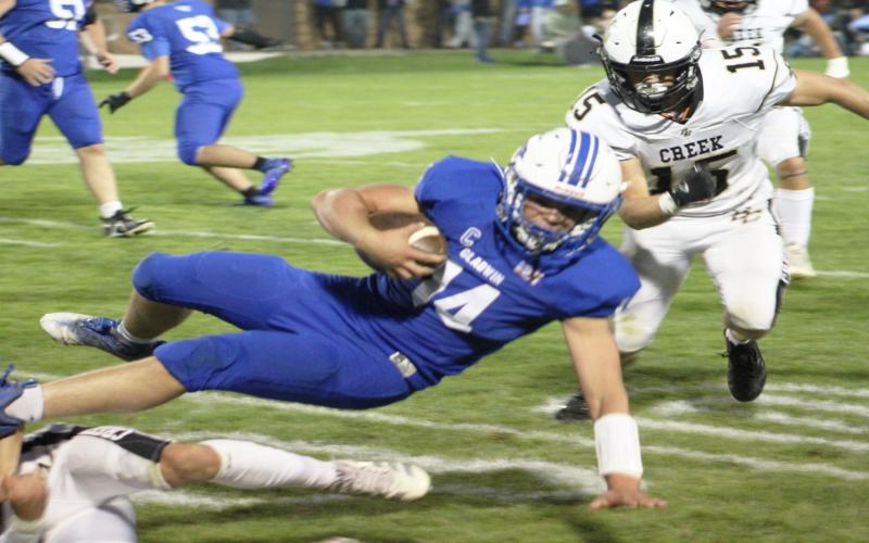 Gladwin’s Preston Willert lunges forward for an extra yard during Friday night’s 50-30 Homecoming victory over Bullock Creek.
