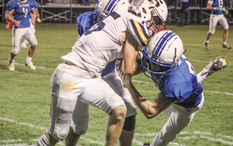 Gladwin’s Preston Willert and Drake Ross team up for a crunching tackle during Friday night’s Homecoming victory over Shepherd.